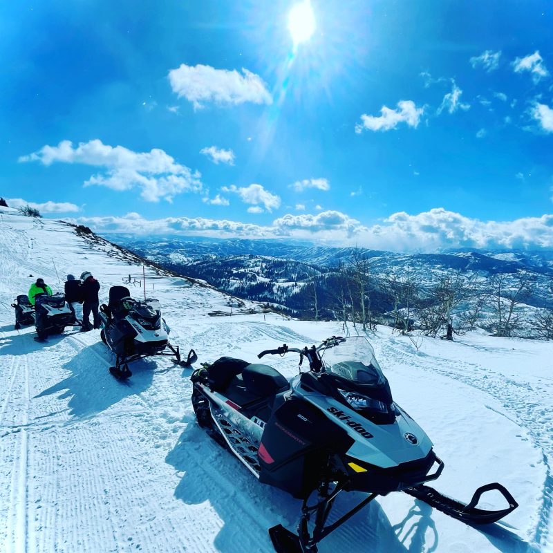 a group of people standing on top of a snow covered mountain