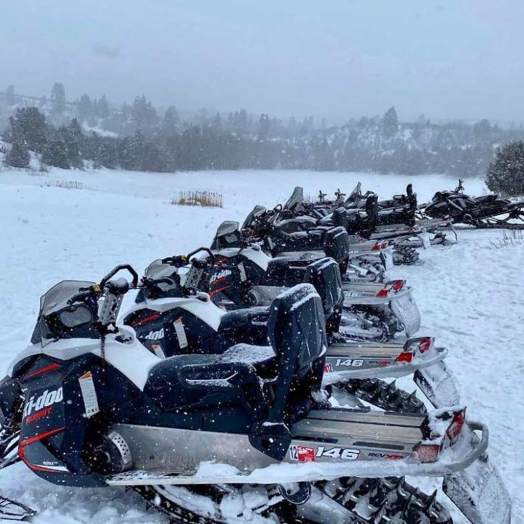 a group of parked motorcycles sitting on the snow