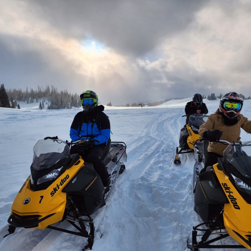 a couple of people that are sitting in the snow