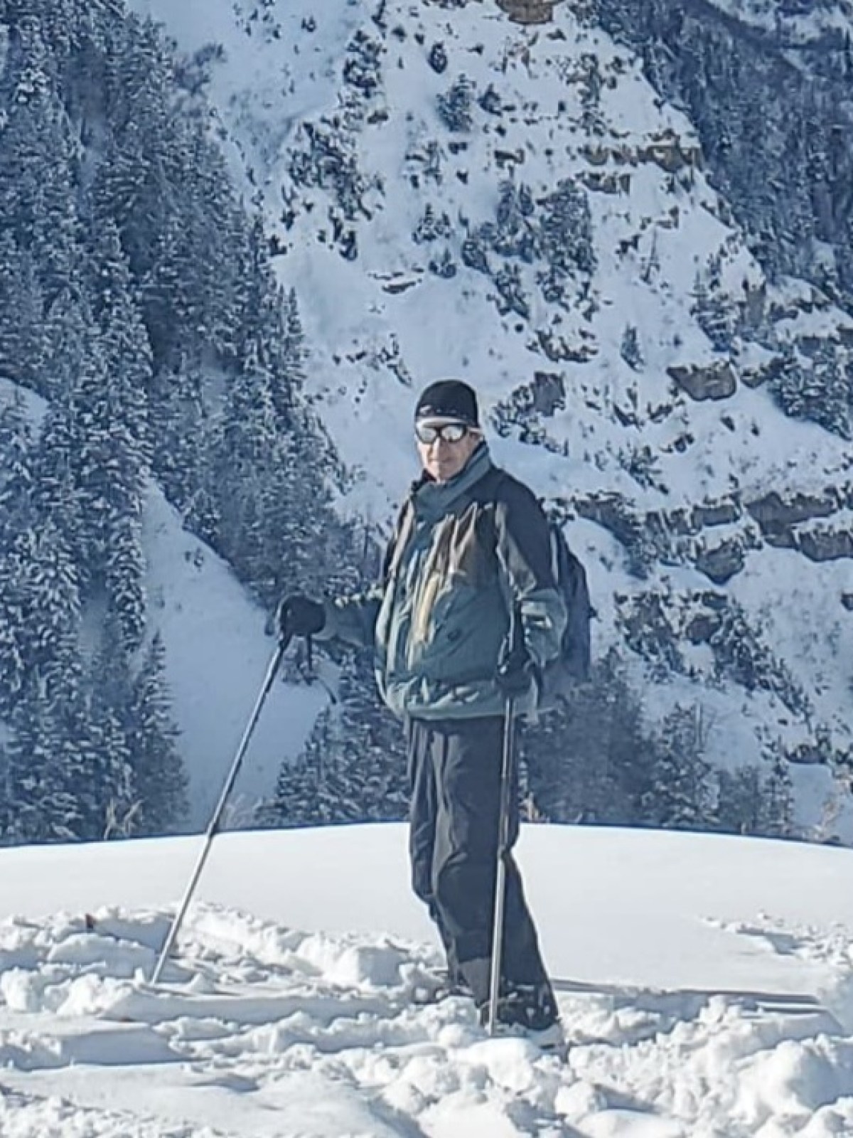 a man standing on top of a snow covered mountain