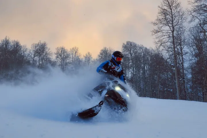 a man riding skis down a snow covered slope