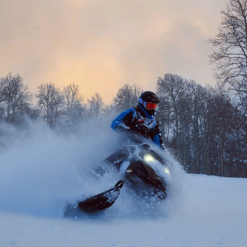 a man riding skis down a snow covered slope