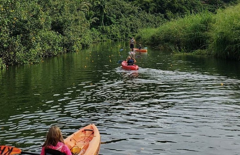 Kayaking in Utah a group of people in a boat on a body of water