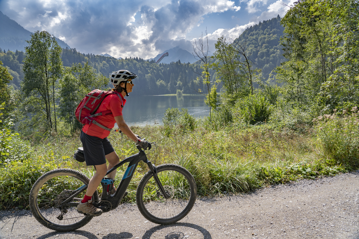 senior woman on electric mountain bike in the Allgau Alps Senior woman riding her electric mountain bike.