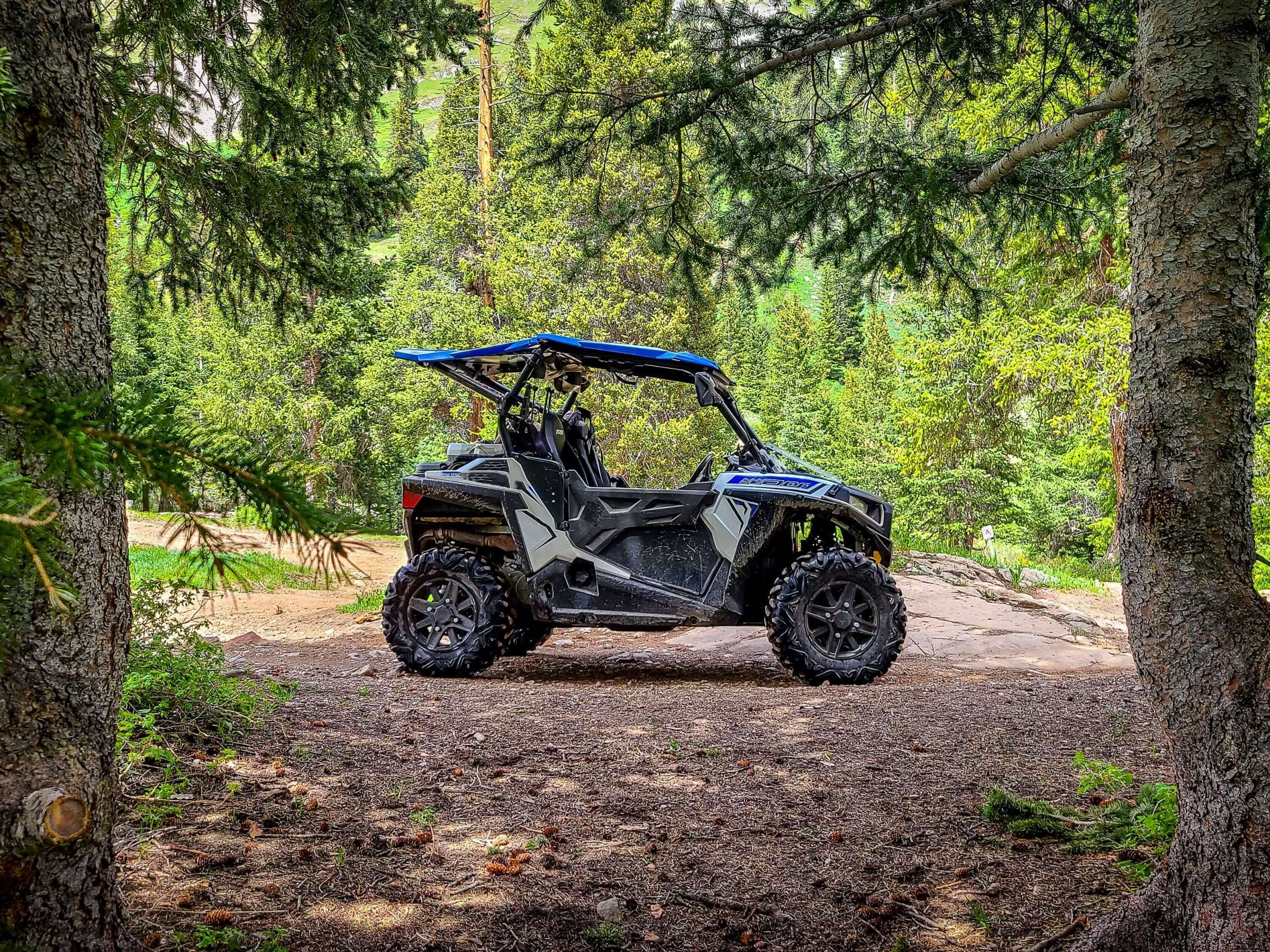 Side by side UTV ATV RZR in the forest.
