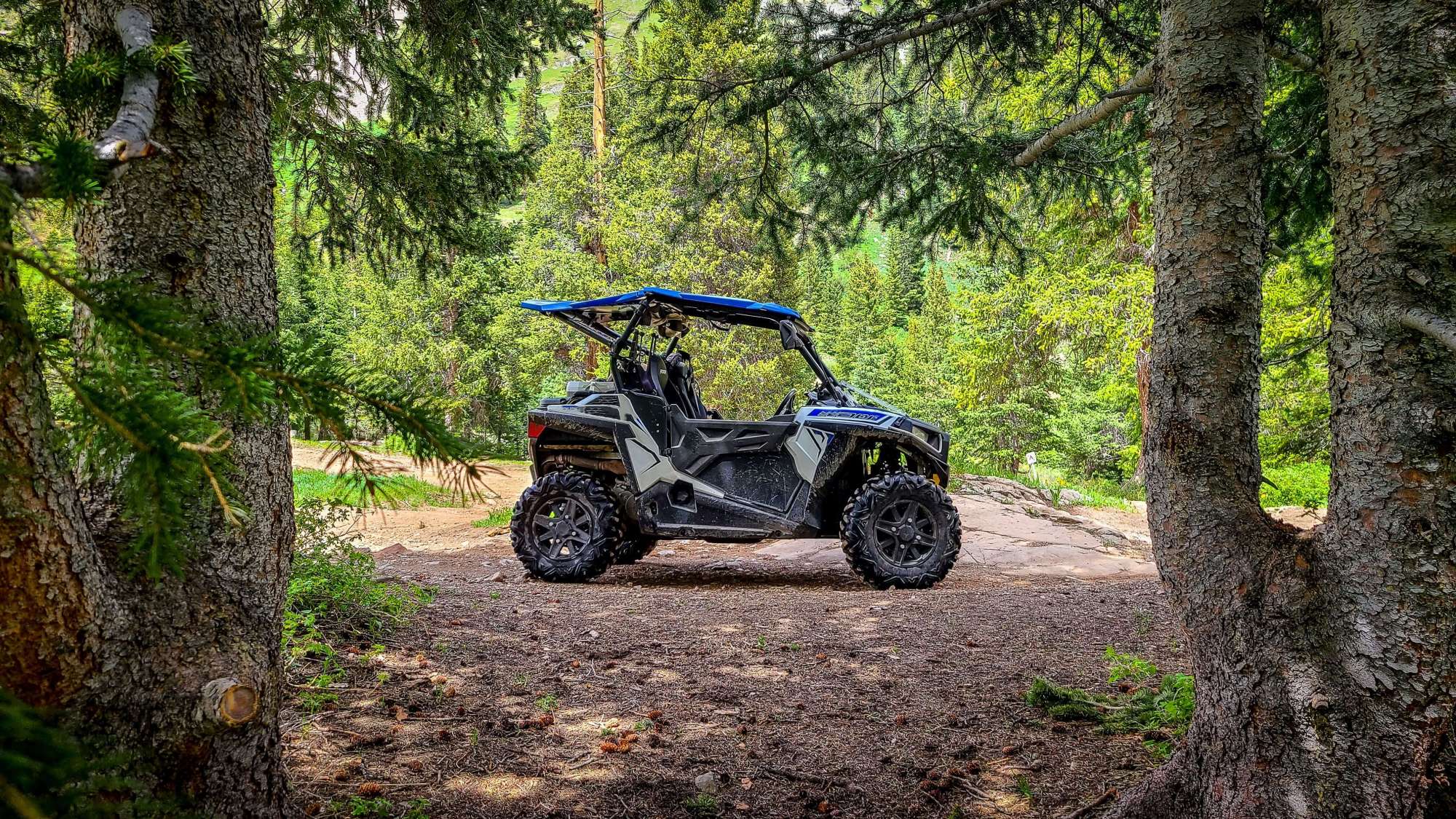 iStock-1407352668-min (1) Side by side UTV ATV RZR in the forest.