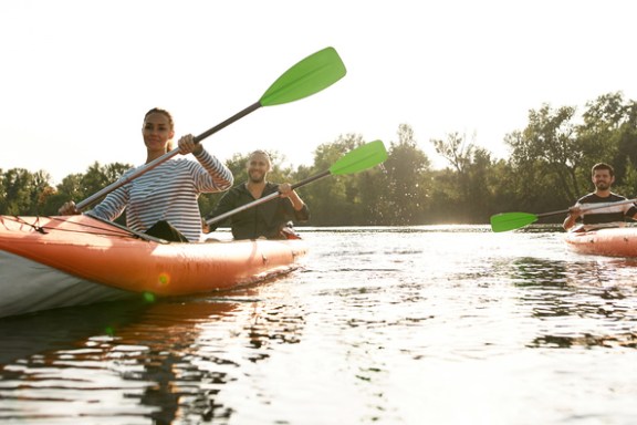 a group of people in a small boat in a body of water