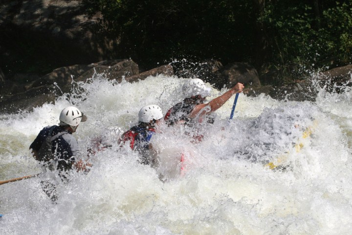 a man riding a wave on top of a body of water