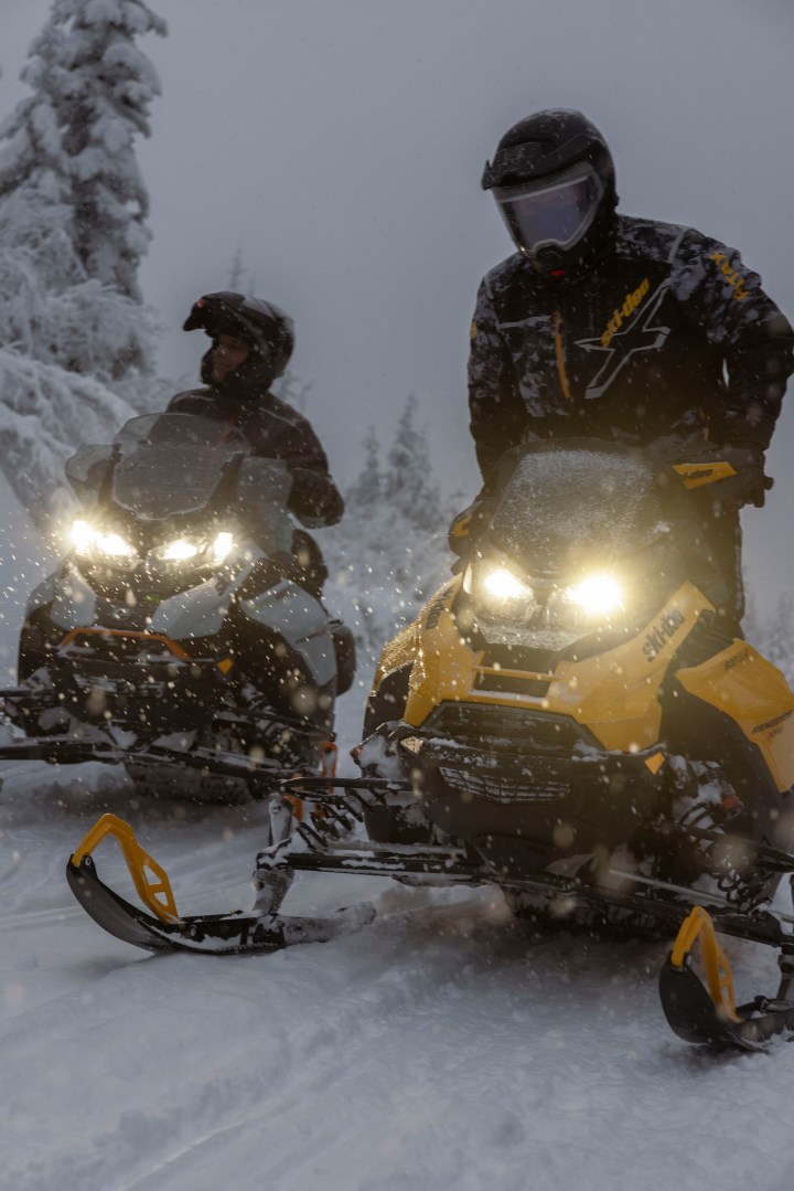 Single rider on a Ski Doo Summit NEO 600 EFI snowmobile in deep snow.
