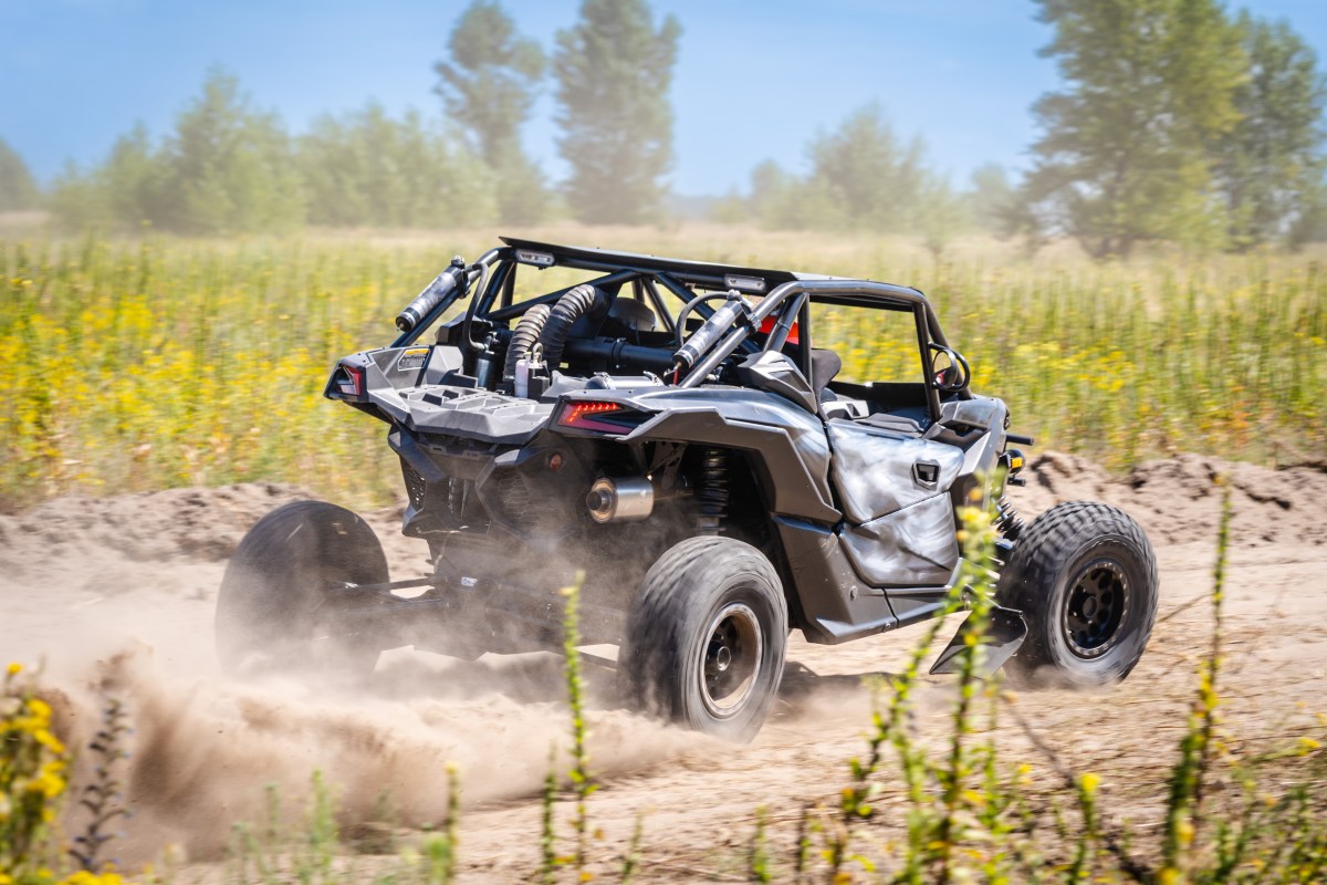 People riding in a Can-Am Maverick Sport UTV while riding on a trail in Utah.