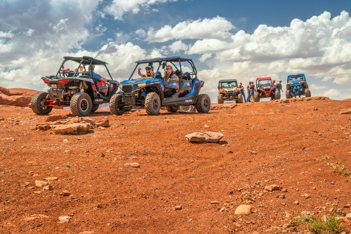 Group of riders enjoying a break in Can-Am Commander DPS UTVs in Utah.