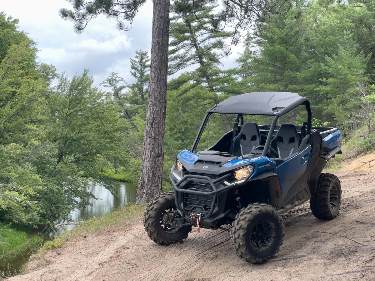 Blue off-road vehicle on a forest trail beside a river. Things to do in park city