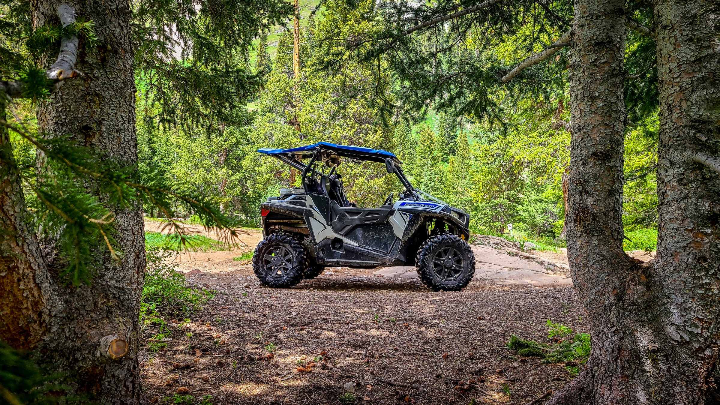 A side by side UTV on a trail in the trees in Heber City, Utah.