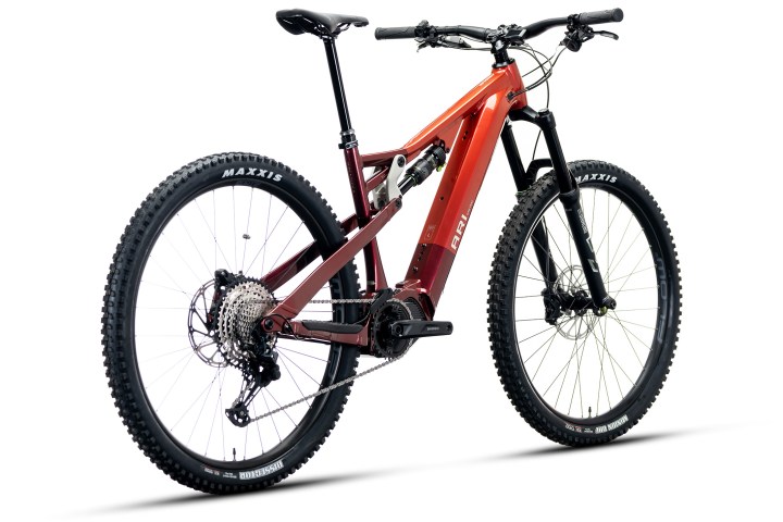 Red and black mountain bike with large tires on a white background.