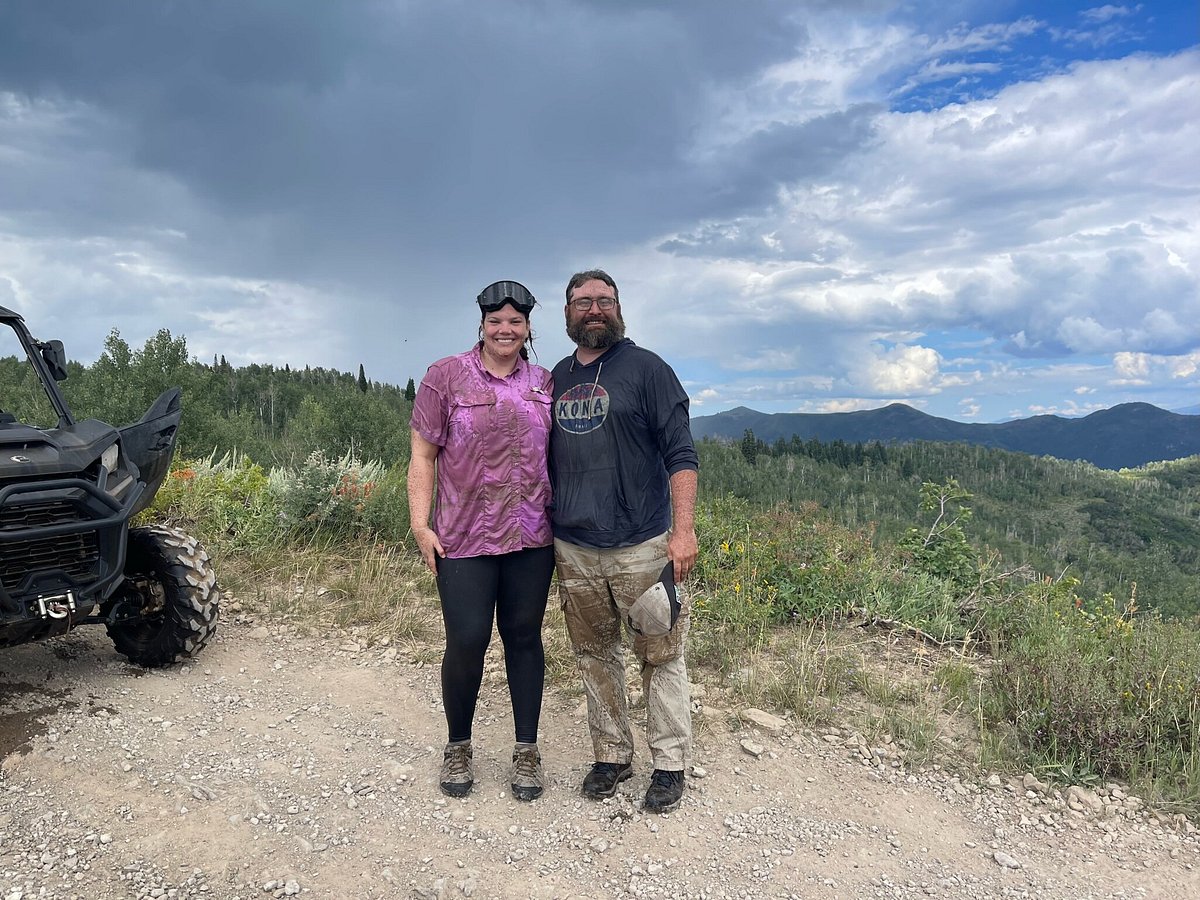 A couple standing near a Can-Am on a trail during a guided UTV tour in Heber City, Utah.