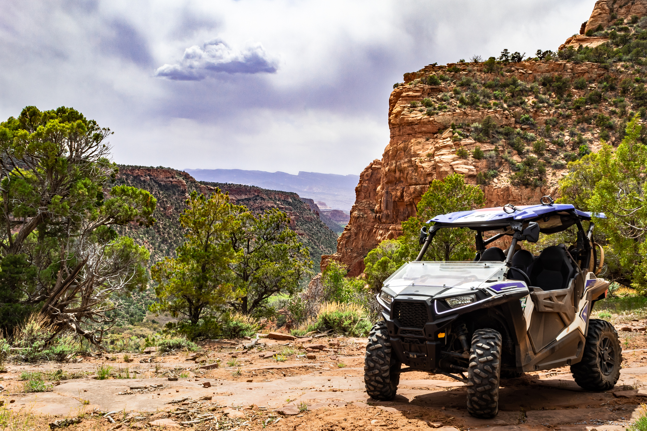 4x4 Side-by-Side off-road vehicle, UTV ATV with a beautiful mountain range in the background near the Uinta-Wasatch-Cache National Forest.